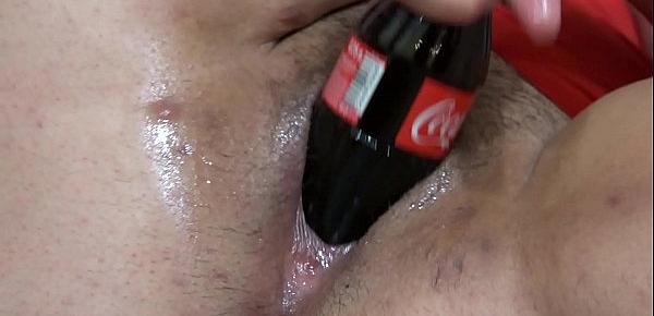 Fat lesbian in a gymnastic pose, and a girlfriend with a big dildo fucks her hairy pussy. And masturbation with a bottle of Coca-Cola. Fetish with a deep, wide hole in a thick cunt.